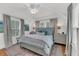 Calm primary bedroom with neutral tones, three bright windows, and a patterned rug at 1466 Mizzen Aly, Johns Island, SC 29455