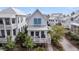 Charming white home with teal shutters, a welcoming front porch, and meticulously landscaped surroundings at 1466 Mizzen Aly, Johns Island, SC 29455