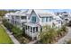 Charming coastal home with white siding, blue shutters, and a inviting front porch with seating at 1466 Mizzen Aly, Johns Island, SC 29455
