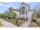 Beautiful exterior view showcasing a home with a porch and a lush landscaped yard at 1466 Mizzen Aly, Johns Island, SC 29455