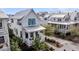 Charming white home showcasing teal shutters, a welcoming front porch, and well-manicured landscaping at 1466 Mizzen Aly, Johns Island, SC 29455