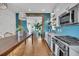 Bright kitchen features stainless steel appliances, blue backsplash, hardwood floors, and adjacent dining area at 1466 Mizzen Aly, Johns Island, SC 29455