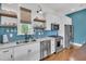 Well-appointed kitchen with stainless steel appliances, open shelving, and sleek countertops at 1466 Mizzen Aly, Johns Island, SC 29455