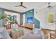 Inviting living room with a television, blue accent wall, and seamless flow to the dining area at 1466 Mizzen Aly, Johns Island, SC 29455