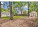 Spacious backyard featuring mature trees, a shed, and partial view of the home at 1531 Seacroft Rd, James Island, SC 29412