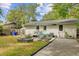 Charming backyard featuring a white brick house, garden, and a gravel-covered patio area perfect for outdoor enjoyment at 1531 Seacroft Rd, James Island, SC 29412