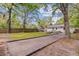 Large backyard with mature trees, home with white siding, and an outdoor seating area at 1531 Seacroft Rd, James Island, SC 29412