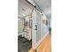 Modern bathroom with a sliding glass door, white subway tile, and a black hexagon tile floor at 1531 Seacroft Rd, James Island, SC 29412