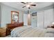 Cozy bedroom with light blue walls, ceiling fan, and a wooden dresser with a mirror at 1531 Seacroft Rd, James Island, SC 29412