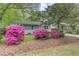 Inviting home exterior with beautiful pink azaleas in the front yard, complemented by lush greenery and a well-maintained lawn at 1531 Seacroft Rd, James Island, SC 29412