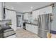 Kitchen featuring white cabinets, stainless appliances, granite countertops and tile flooring at 1531 Seacroft Rd, James Island, SC 29412