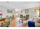 View of living room with hardwood floors, a neutral sofa, and large windows at 1531 Seacroft Rd, James Island, SC 29412