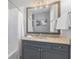 Well-lit bathroom featuring a vanity with granite countertop and tub with white tile surround at 1555 Willtown St, Daniel Island, SC 29492