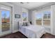 Cozy bedroom with natural light and dark wood floors and a balcony with a view of the neighborhood at 1555 Willtown St, Daniel Island, SC 29492