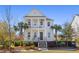 Charming two-story home boasting double porches, columns, and lush landscaping, offering classic curb appeal at 1555 Willtown St, Daniel Island, SC 29492