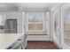 Kitchen with white cabinets, stainless appliances, a built-in bench and access to the back porch at 1555 Willtown St, Daniel Island, SC 29492