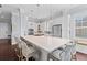 Spacious white kitchen has an oversized island, stainless appliances, and a built-in window seat at 1555 Willtown St, Daniel Island, SC 29492
