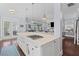 Open concept kitchen features a stovetop in the island, stainless appliances and hardwood floors at 1555 Willtown St, Daniel Island, SC 29492