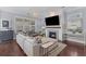 Bright living room features a fireplace, hardwood floors, a large sofa and updated lighting at 1555 Willtown St, Daniel Island, SC 29492