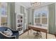 Cozy home office with natural light, custom bookcase, and stylish furnishings, creating an ideal workspace at 1555 Willtown St, Daniel Island, SC 29492