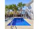 Private backyard with a refreshing pool surrounded by lush greenery, offering a tranquil escape at 1555 Willtown St, Daniel Island, SC 29492