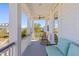 Relaxing porch area with comfortable seating and ceiling fan overlooking the community at 1555 Willtown St, Daniel Island, SC 29492