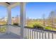 Inviting porch view overlooking a well-manicured lawn and surrounding neighborhood homes at 1555 Willtown St, Daniel Island, SC 29492