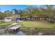 Aerial view of a beautiful home with lush greenery, waterfront access, and private dock at 1673 Mcclain St, Charleston, SC 29407