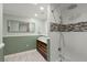 Bathroom featuring double sinks, modern vanity, walk in shower and natural light at 1673 Mcclain St, Charleston, SC 29407