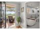 An outdoor patio with a cozy seating area and a luxurious bathroom featuring a modern soaking tub at 1673 Mcclain St, Charleston, SC 29407