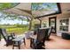 Relaxing deck area with a shaded canopy, fire pit, and a view of the backyard and canal at 1673 Mcclain St, Charleston, SC 29407