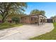Charming brick home with a covered carport and mature trees, offering a welcoming curb appeal at 1673 Mcclain St, Charleston, SC 29407
