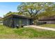 Contemporary black garage with climbing vines adding a touch of greenery and charm at 1673 Mcclain St, Charleston, SC 29407