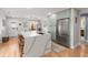 Bright kitchen boasts a large island with bar seating, stainless steel appliances, and stylish light fixtures at 1673 Mcclain St, Charleston, SC 29407