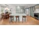 Modern kitchen features a large island with bar stools, sleek light green cabinets, and stainless steel appliances at 1673 Mcclain St, Charleston, SC 29407
