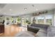 Bright and airy living room with large windows, comfortable seating, and hardwood floors at 1673 Mcclain St, Charleston, SC 29407