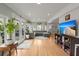 Open living room featuring hardwood floors, a comfortable sofa, and a large television at 1673 Mcclain St, Charleston, SC 29407