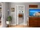Bright living room with hardwood floors, a modern media center, and a peek into the stylish bathroom at 1673 Mcclain St, Charleston, SC 29407