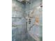 Close up of a shower featuring luxurious blue stone tiling, a niche, and modern fixtures for a spa-like experience at 1673 Mcclain St, Charleston, SC 29407