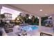 Relaxing pool area with ample seating, lounge chairs, and a clear view of the lush backyard at 1715 Middle St, Sullivans Island, SC 29482