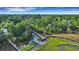 Stunning aerial view of a dock extending into the water, surrounded by lush greenery and trees at 1857 W Canning Dr, Mount Pleasant, SC 29466