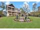 Expansive backyard with a fire pit area, a large screened porch and lush landscaping at 1857 W Canning Dr, Mount Pleasant, SC 29466