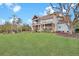 Spacious backyard featuring a fire pit, patio, screened porch, and mature trees at 1857 W Canning Dr, Mount Pleasant, SC 29466