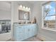 Bathroom featuring a vanity with stone countertop, a mirror with mosaic tile frame, and a window with view at 1857 W Canning Dr, Mount Pleasant, SC 29466
