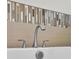 Close-up on faucet and decorative tile detailing the bathtub in the modern bathroom at 1857 W Canning Dr, Mount Pleasant, SC 29466