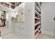 Walk-in closet with custom shelving, drawers, and a full-length mirror for ample storage at 1857 W Canning Dr, Mount Pleasant, SC 29466