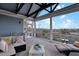 Serene covered deck with comfortable seating, cable railings, and scenic views of the surrounding nature at 1857 W Canning Dr, Mount Pleasant, SC 29466
