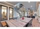 Inviting covered patio features outdoor dining with a spiral staircase and fireplace in the background at 1857 W Canning Dr, Mount Pleasant, SC 29466