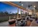 Spacious covered patio features comfortable seating, a backyard view, and a spiral staircase for outdoor relaxation at 1857 W Canning Dr, Mount Pleasant, SC 29466