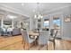 This well-lit dining room features hardwood floors, and an elegant chandelier and is open to the living room at 1857 W Canning Dr, Mount Pleasant, SC 29466